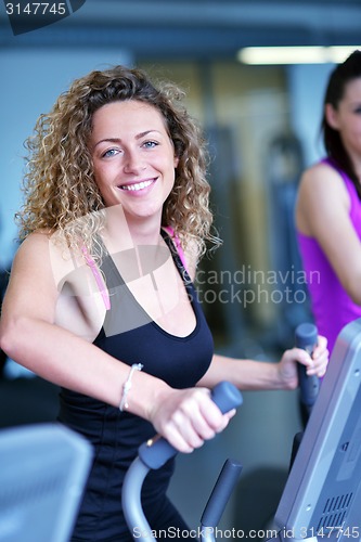 Image of woman exercising on treadmill in gym