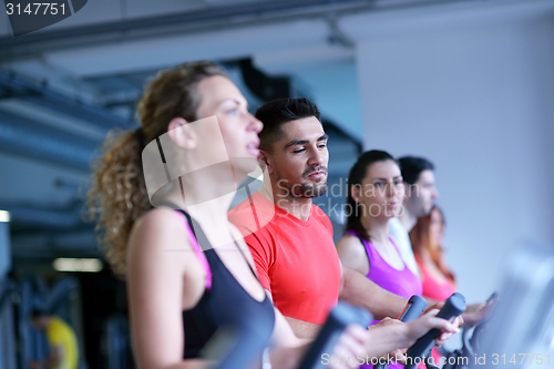 Image of Group of people running on treadmills