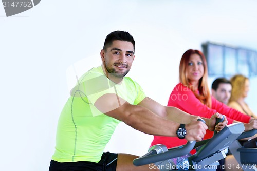 Image of Group of people running on treadmills