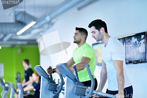 Image of Group of people running on treadmills