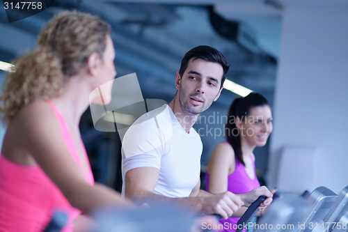 Image of Group of people running on treadmills