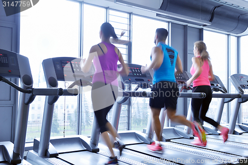 Image of Group of people running on treadmills