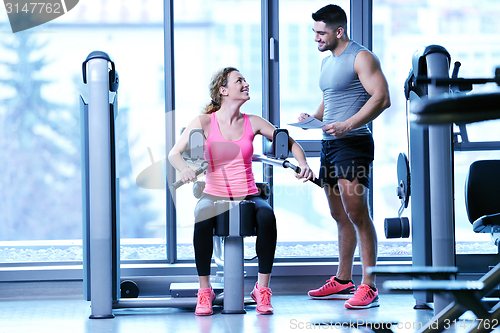 Image of woman exercising with her personal trainer