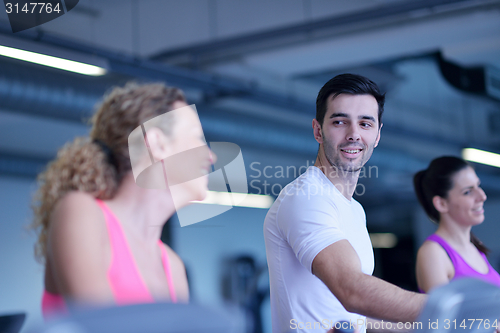 Image of Group of people running on treadmills