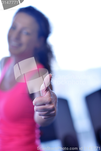 Image of woman exercising on treadmill in gym