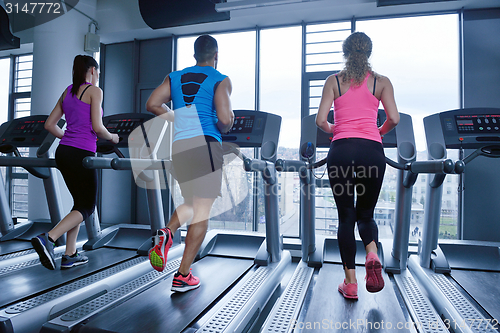 Image of Group of people running on treadmills