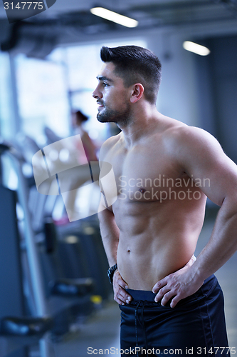 Image of handsome man exercising at the gym