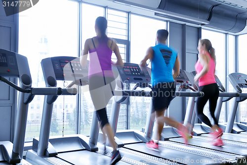 Image of Group of people running on treadmills