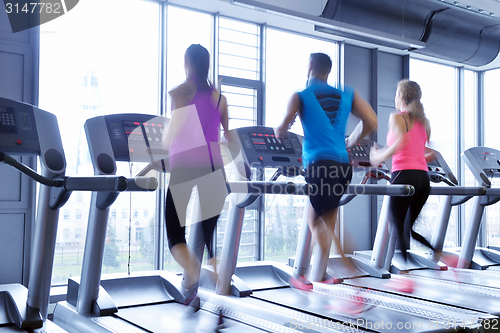 Image of Group of people running on treadmills