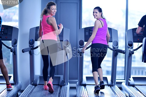 Image of Group of people running on treadmills