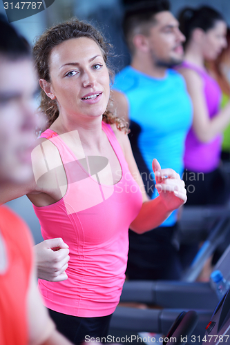 Image of woman exercising on treadmill in gym