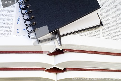 Image of Notebook and Pen on Books
