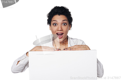 Image of Surprised business woman showing blank credit card