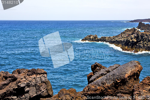 Image of hervideros brown rock in white coast lanzarote    ummer 