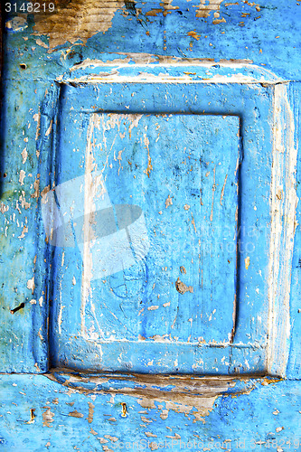 Image of nail stripped paint  wood door and rusty 