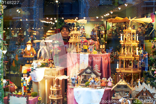 Image of Woman look through Showcase toy shop Bruges. Belgium