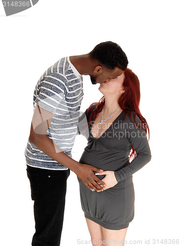Image of Pregnant woman kissing husband.