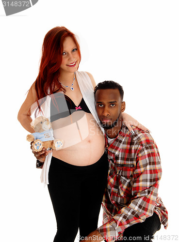Image of Man hugging baby belly.