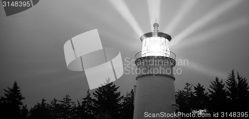 Image of Lighthouse Beams Illumination Into Rain Storm Maritime Nautical 