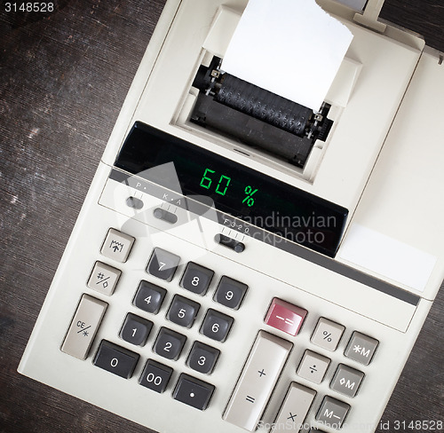 Image of Old calculator showing a percentage - 60 percent