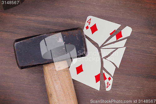 Image of Hammer with a broken card, four of diamonds