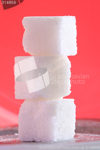 Image of Close-up of three sugar cubes on pink