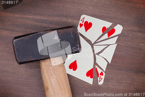 Image of Hammer with a broken card, four of hearts