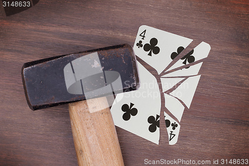 Image of Hammer with a broken card, four of clubs