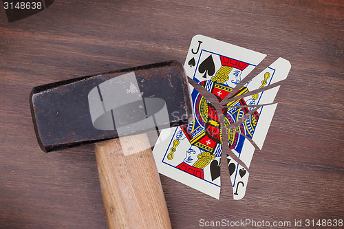 Image of Hammer with a broken card, jack of spades