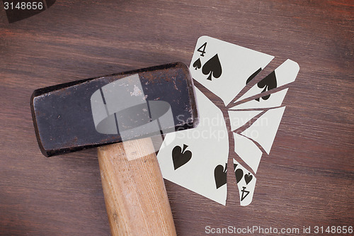 Image of Hammer with a broken card, four of spades