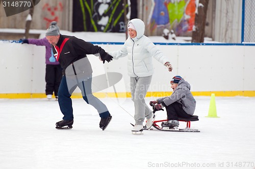 Image of Happy family with a sledge