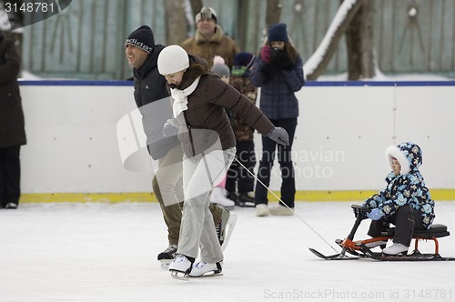 Image of Happy family with a sledge