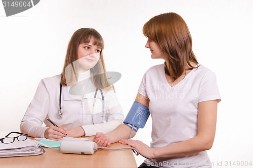 Image of The doctor measures pressure to the patient