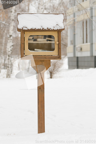 Image of A small library with free books on the street in the form of house