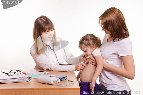 Image of Pediatrician listening to baby's breath stethoscope