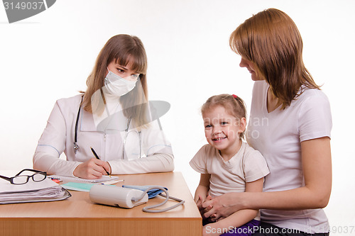 Image of Young mother with her child sitting in his office at the pediatrician