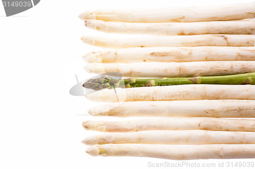 Image of Green Asparagus Amidst Ten White Asparagus Spears