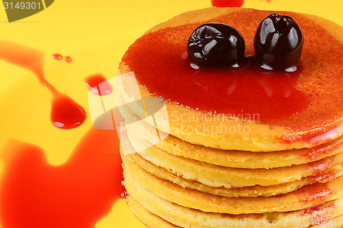 Image of Pancakes with syrup and sour cherries