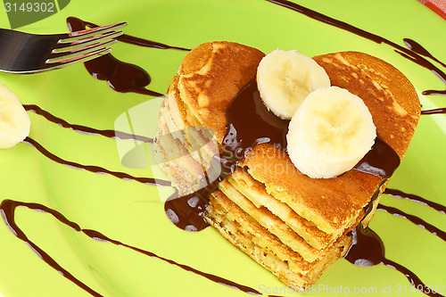 Image of Heart shaped pancakes with chocolate sauce and banana