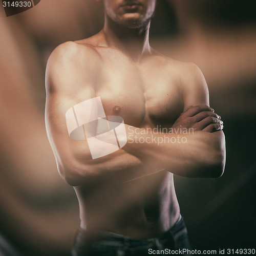 Image of Muscular naked man on black