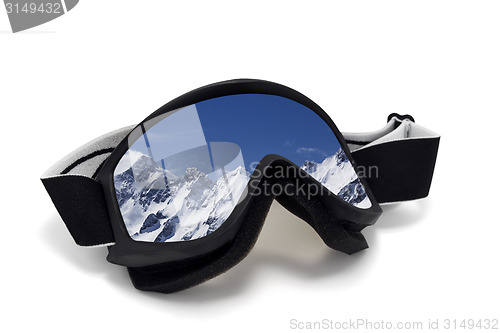 Image of Ski goggles with reflection of snowy mountains