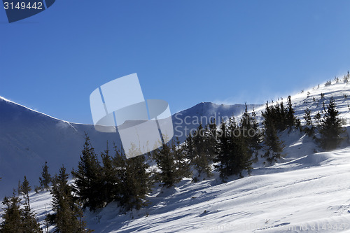 Image of Winter mountains at sun windy day