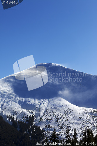 Image of Winter mountains at sun windy day