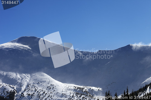 Image of Winter mountains at sunny windy day