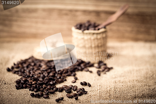 Image of pile of fresh and bio aromatic coffee beans and spoon