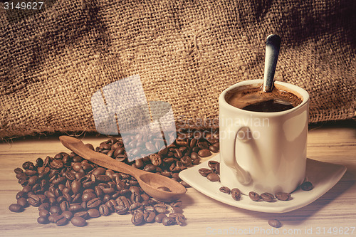 Image of pile of fresh beans, cap, and spoon