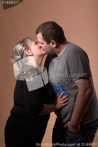 Image of Beautiful xxl woman kissing her husband
