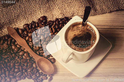 Image of pile of fresh beans, cap, and spoon