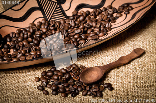 Image of pile of fresh and bio aromatic coffee beans and spoon