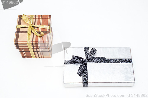 Image of brown and silver gift box with bow on white background